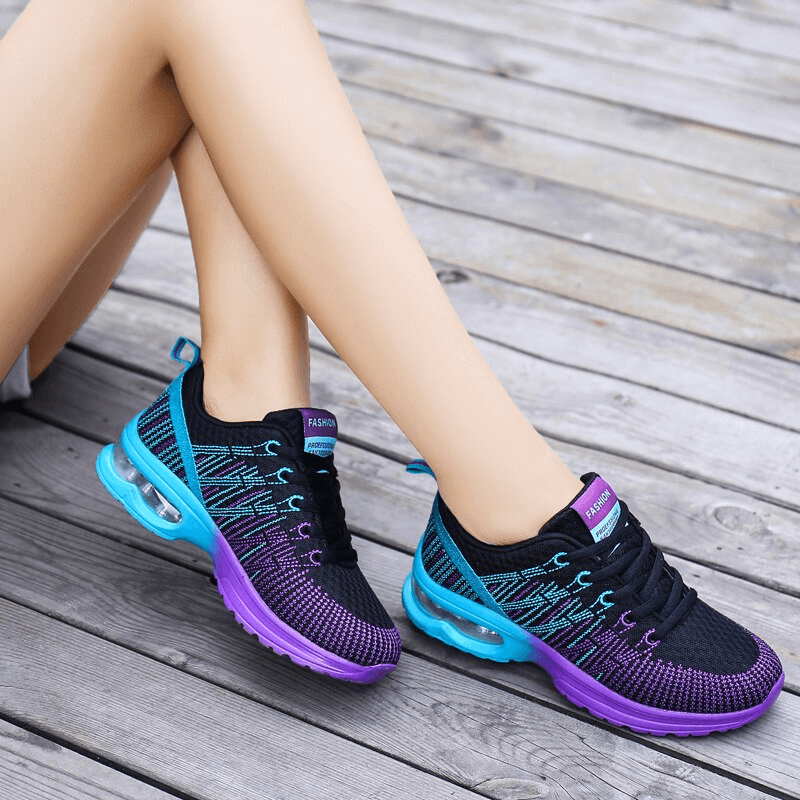 Stylish bright mesh women's sneakers, breathable sports shoes SF0876, with purple and blue design on wooden floor.
