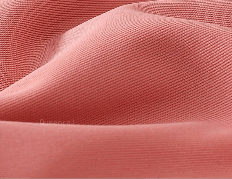 Close-up of soft pink spandex fabric, showcasing the breathable and elastic material used in women's sports bras.