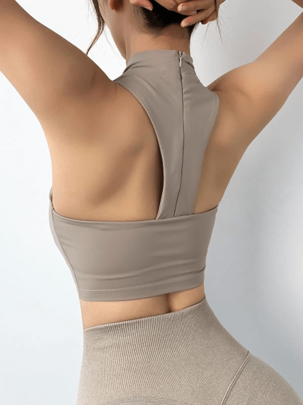 Woman wearing a stylish open-back elastic sports bra, perfect for fitness. Features breathable, quick-dry nylon for comfort. Model SF1260.