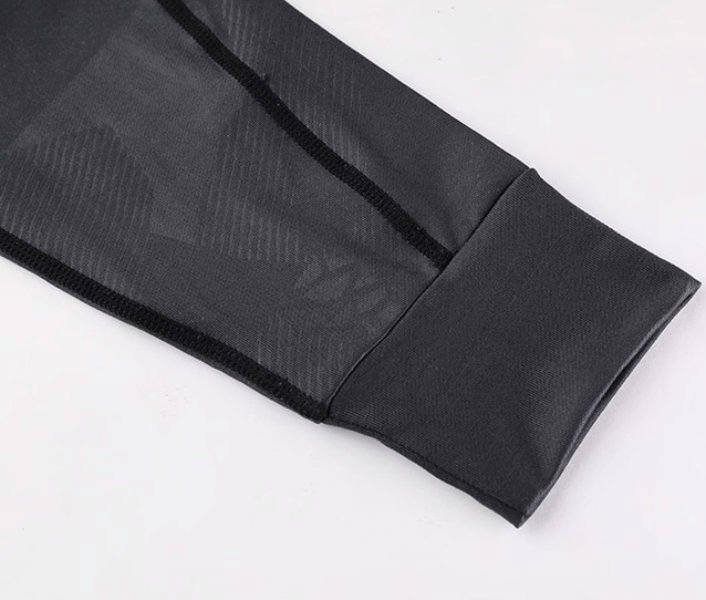 Close-up of stylish elastic sports men's hoodie sleeve detail in black, showing windproof and quick-drying fabric.