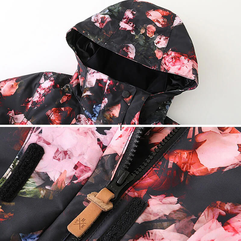 Close-up of stylish floral waterproof ski jacket, featuring a hooded collar and durable zipper, perfect for winter sports.