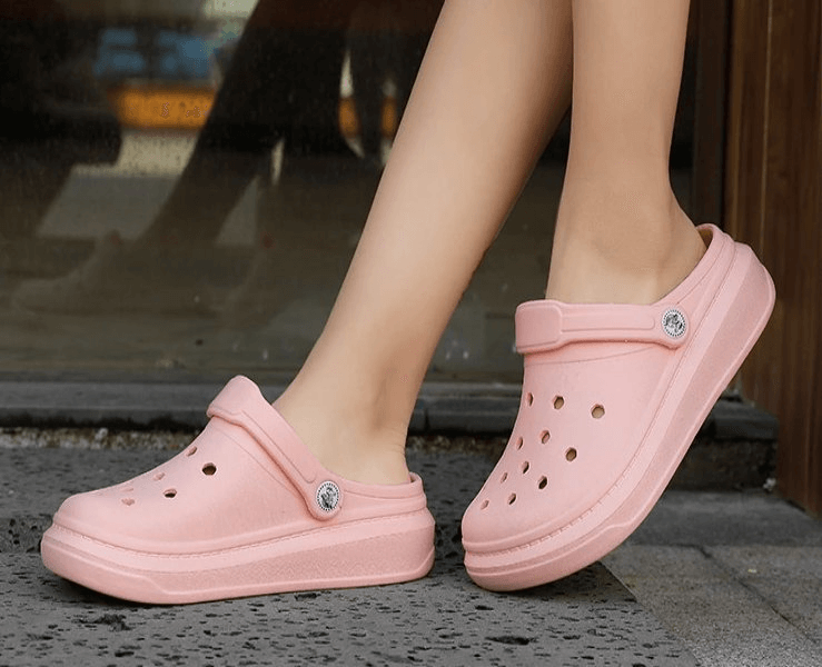Pink lightweight unisex Crocs with EVA material, featuring a platform and front strap, perfect for casual wear and superior comfort.