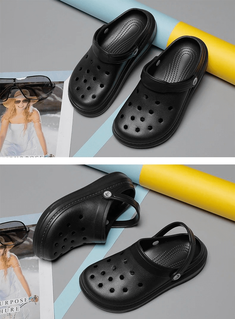 Black stylish unisex crocs with flexible design and back straps, placed on colorful background.