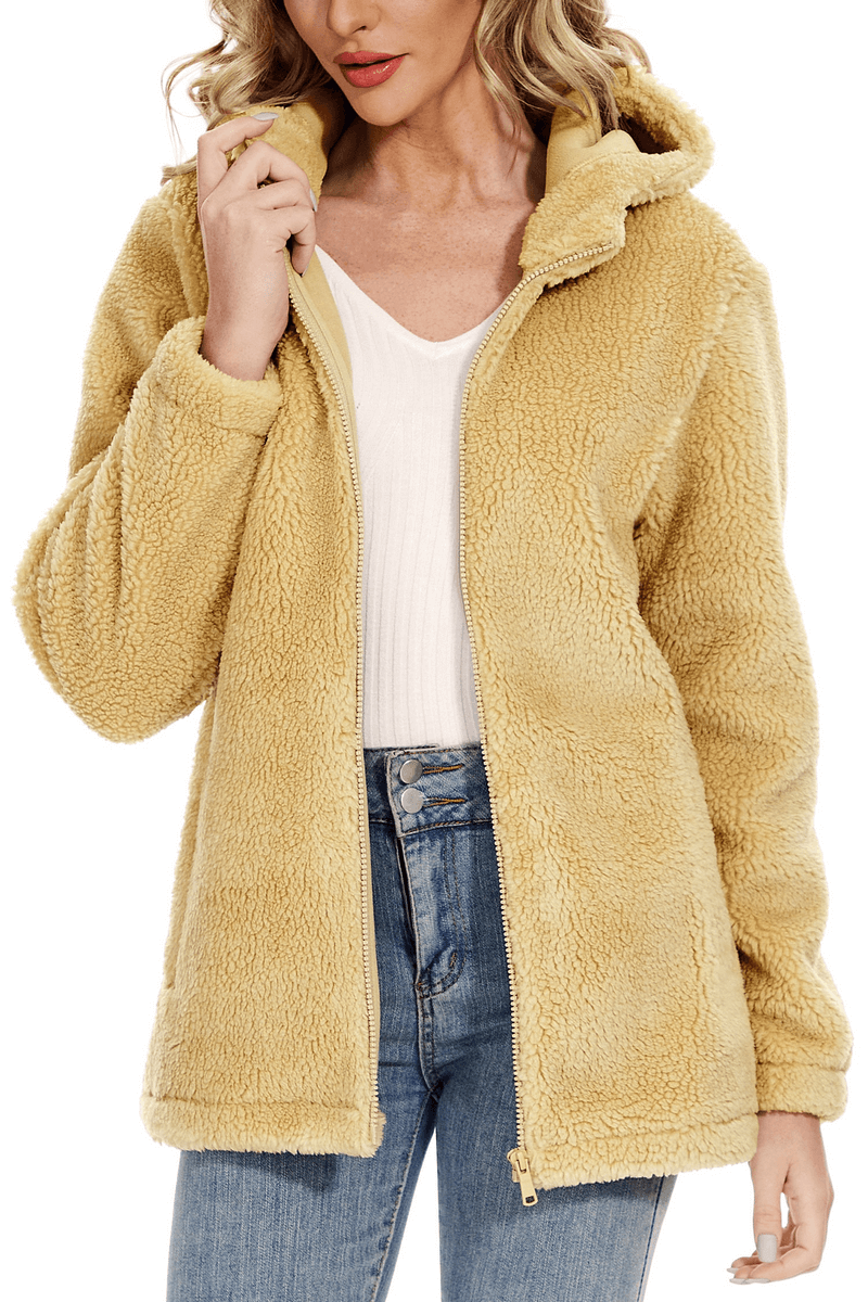 Woman wearing a stylish fluffy jacket with hood and zipper, SF0905, in cozy beige color, perfect for chilly weather fashion.