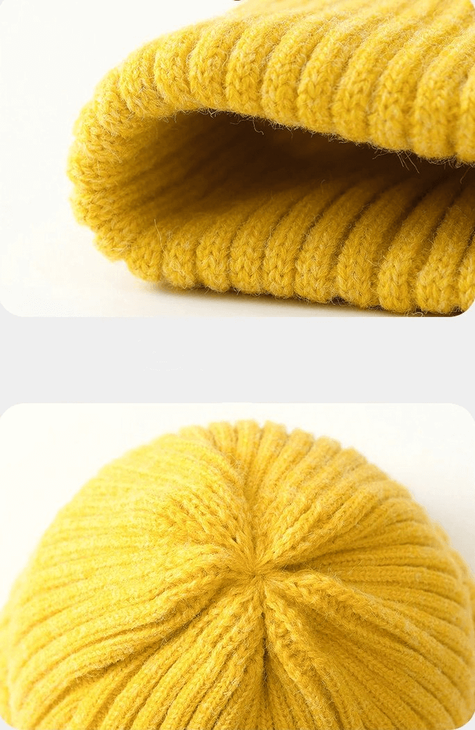 Close-up of a yellow stylish knitted women's hat made of soft acrylic and woolen fabric, showcasing the cozy material and ribbed texture.