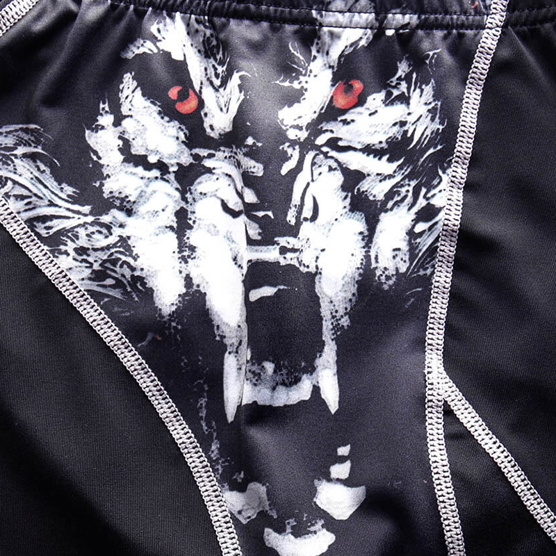 Close-up of a stylish long sleeve sports top with a fierce wolf face design and red eyes, emphasizing compression and flexibility.