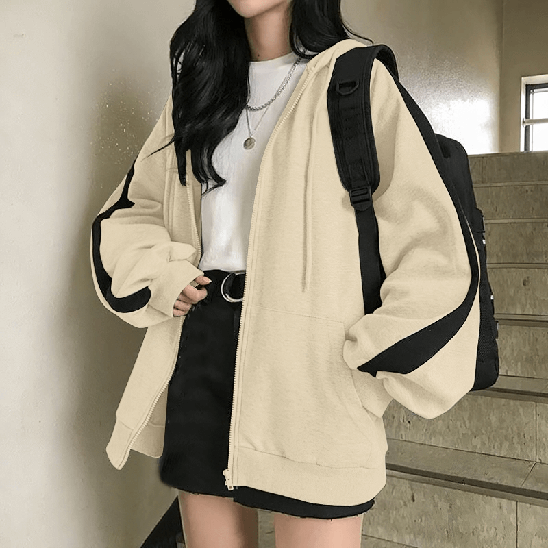 Woman wearing stylish loose zipper hoodie in beige with black accents, perfect for casual occasions and offering comfort and warmth. SF0086