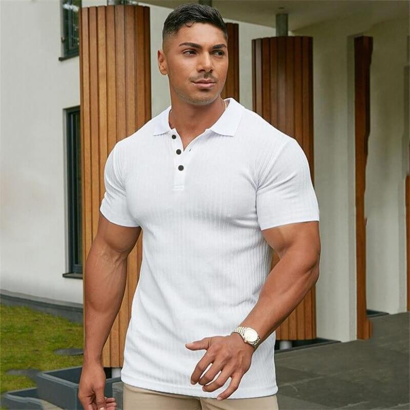 Man wearing a white stylish polo t-shirt with buttons in a casual outdoor setting.