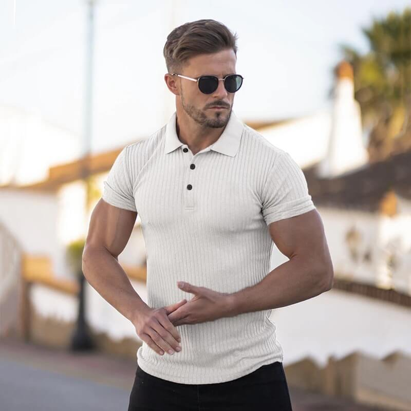 Man wearing stylish white polo t-shirt with buttons and sporty stripes, showcasing slim fit and timeless style in outdoor setting.