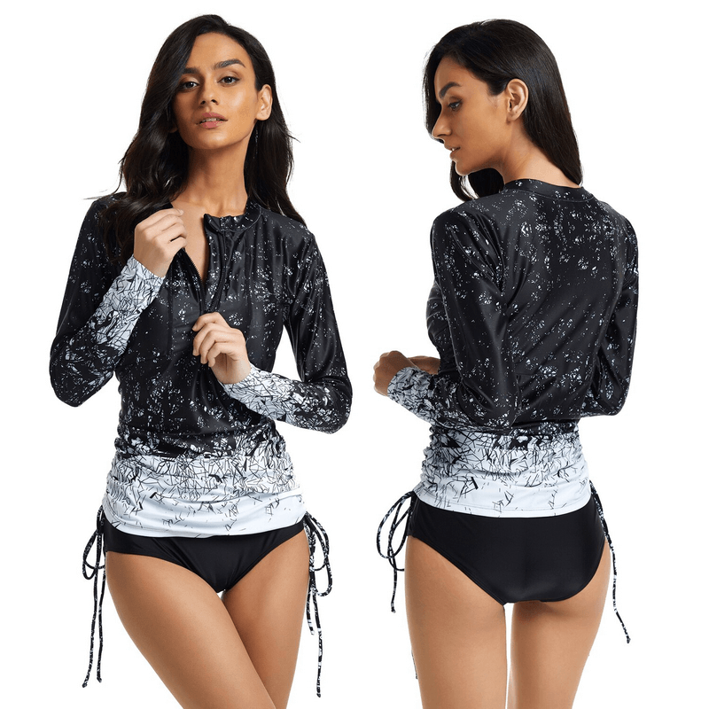 Woman models Stylish Printed Quick-Dry Transformer Swimsuit in black and white with long sleeves and unique print design.