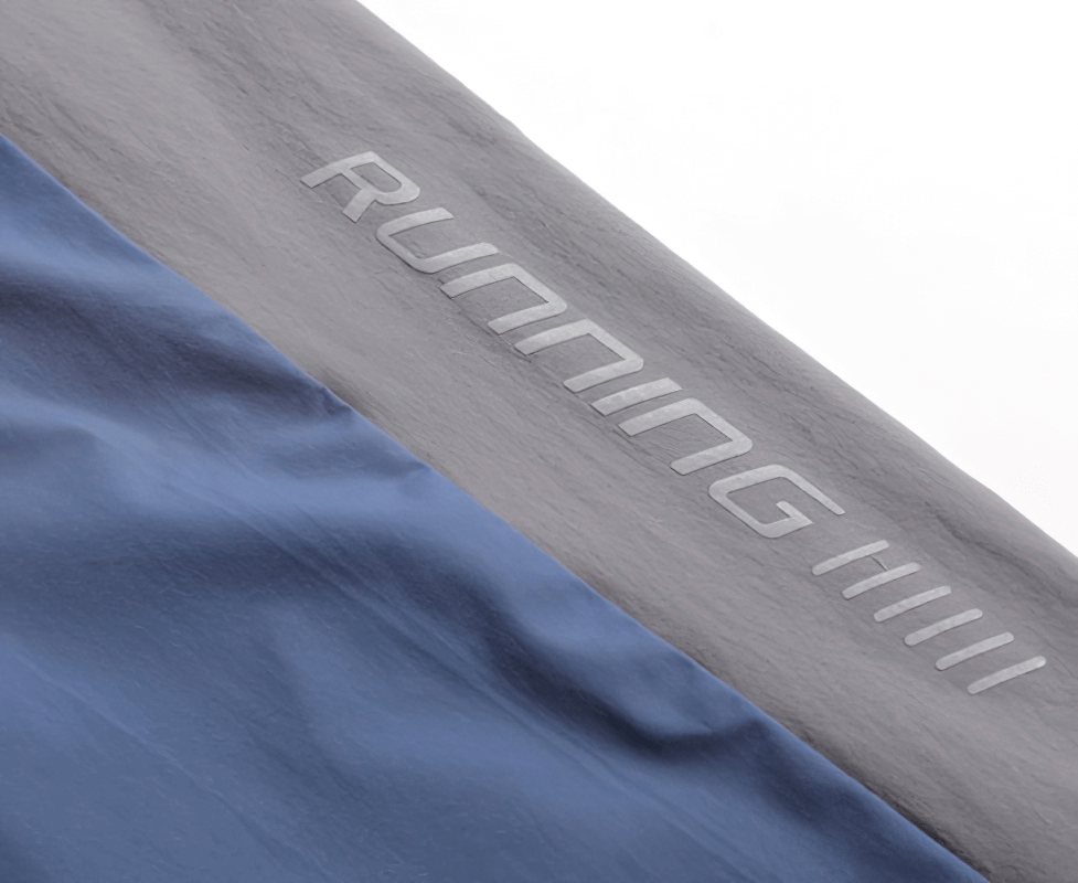 Close-up of stylish quick-drying sporty men's pants with 'Running' print and cuff detail, perfect for training.