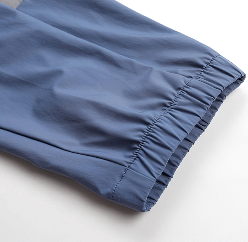 Close-up of blue sporty men's pants cuff with elastic, ideal for running. Stylish and quick-drying for a snug athletic fit.