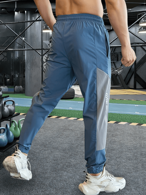 Stylish quick-drying sporty men's pants with cuffs, perfect for training and running, shown in a gym setting.