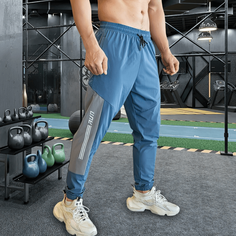 Stylish quick-drying sporty men's pants with cuffs for training, perfect for running, shown in gym setting, SF0743.