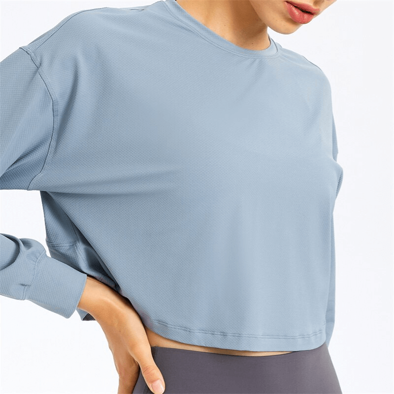 Stylish sport short women's sweatshirt with long sleeves in light blue, ideal for yoga. Breathable spandex material for comfort.