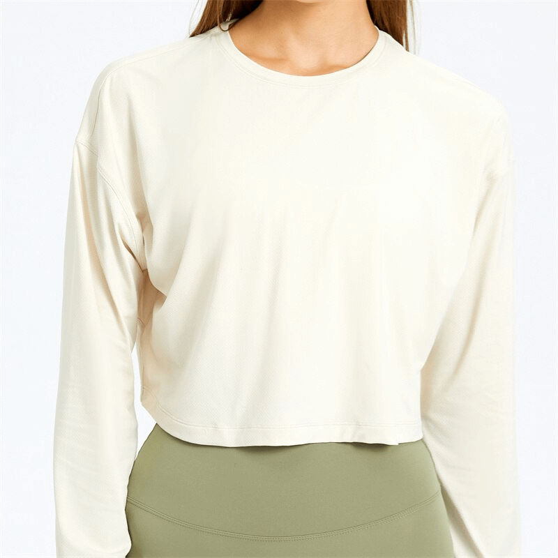 Stylish sport short women's sweatshirt in cream with long sleeves, perfect for yoga, made from breathable spandex material.