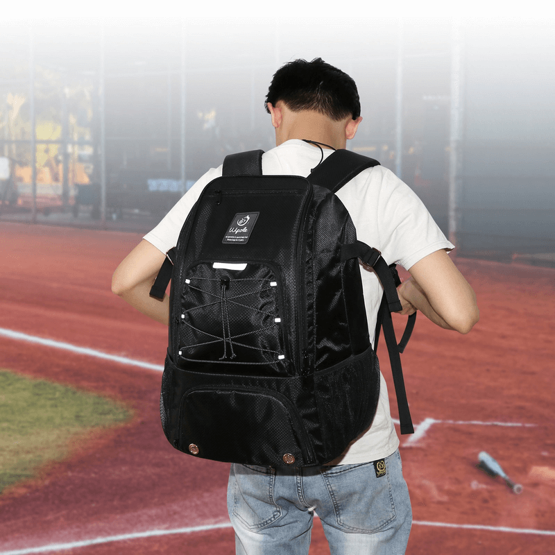Unisex sports backpack with spacious pockets, worn by person on a sports field. Stylish, durable nylon design for training.