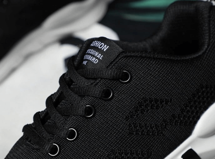 Stylish black breathable women's sneakers with laces, featuring a sleek design and comfortable fit, perfect for an active lifestyle.