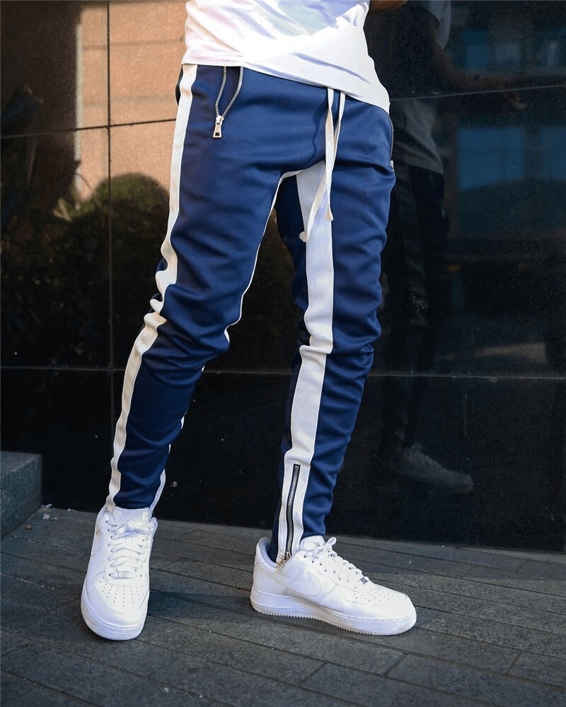 Stylish two-tone men's jogging pants with zipper pockets, featuring a blue and white design, ideal for running and casual wear.