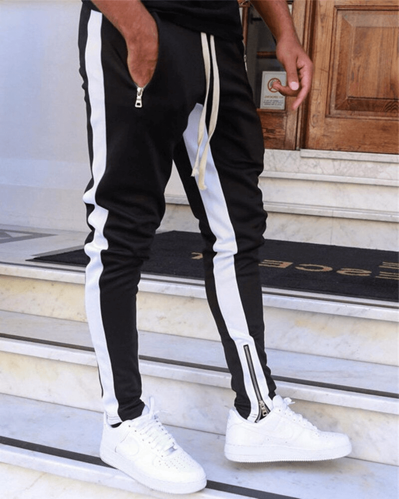 Stylish two-tone men's jogging pants with zipper pockets, ideal for running. Made of high-quality cotton for breathability and comfort.