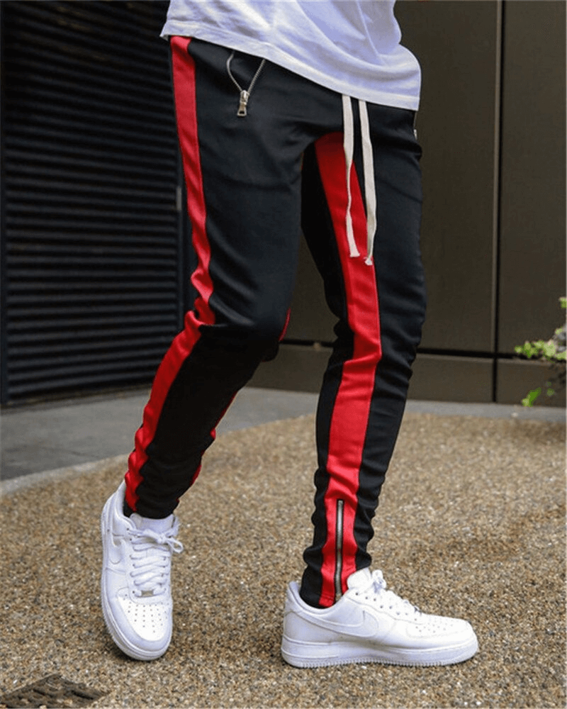 Stylish two-tone jogging pants for men with red side stripes and zip pockets, perfect for sports and casual wear.