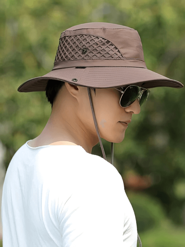 Alt Tag: Unisex breathable sun hat with adjustable brim, stylishly worn outdoors. Ideal for sun protection in any travel or casual setting.