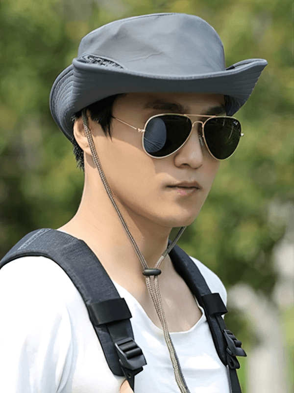 Person wearing a stylish unisex breathable sun hat with an adjustable brim, perfect for outdoor activities and sun protection.