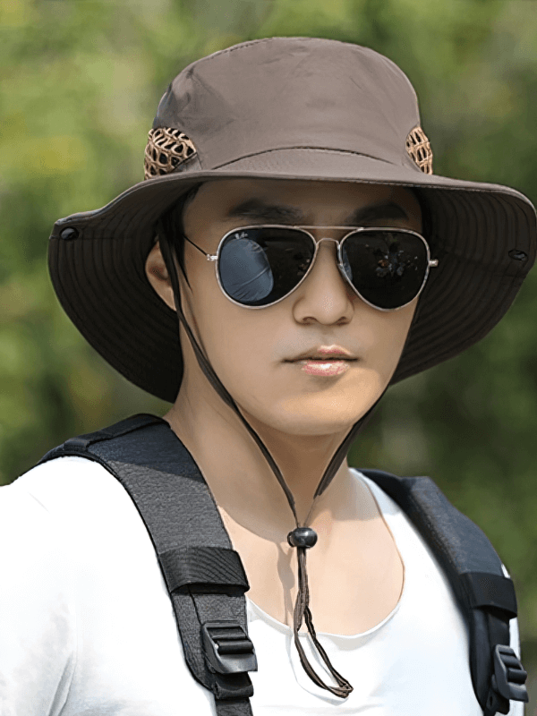 Unisex breathable sun hat with adjustable brim, perfect for outdoor adventures, shown on a person wearing sunglasses and a backpack.