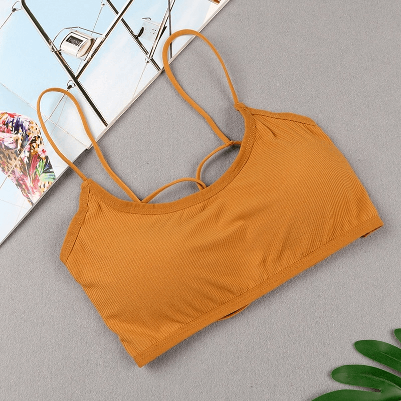Stylish wireless women's sports bra with open back in mustard color, perfect for yoga and activewear. Made from breathable modal.