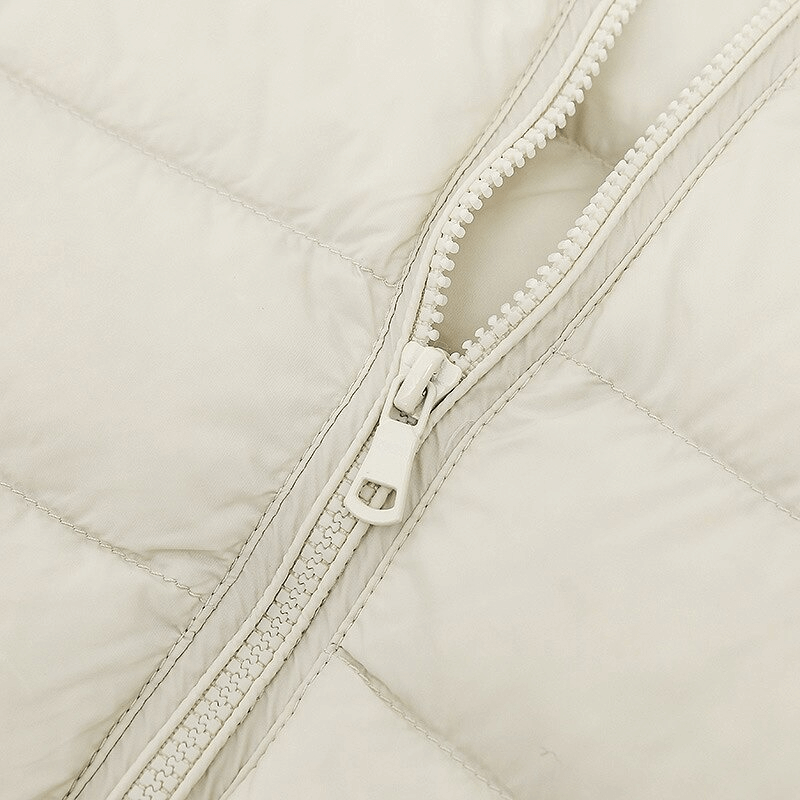 Close-up of white zip on stylish women's down jacket SF0108, showcasing lightweight nylon and elegant design for weather protection.