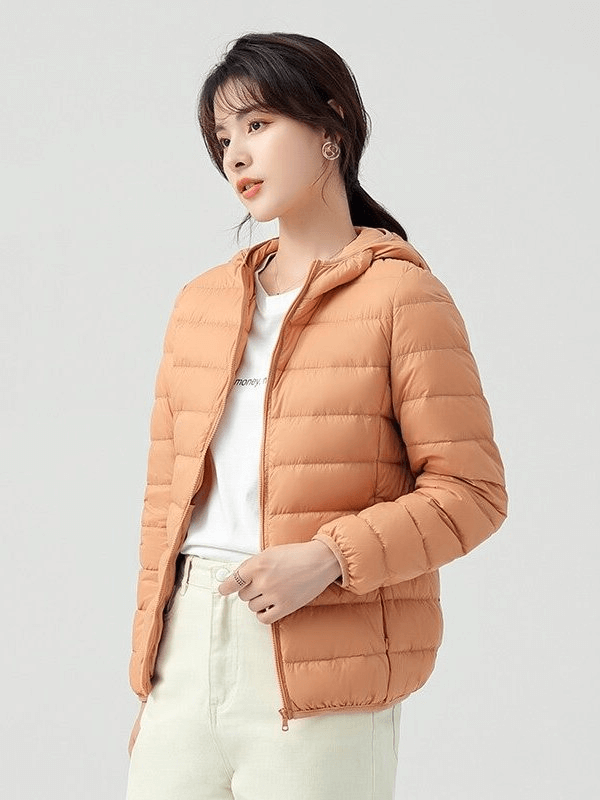 Woman wearing stylish down jacket with hood, SF0108, lightweight and windproof, perfect for outdoor adventures.