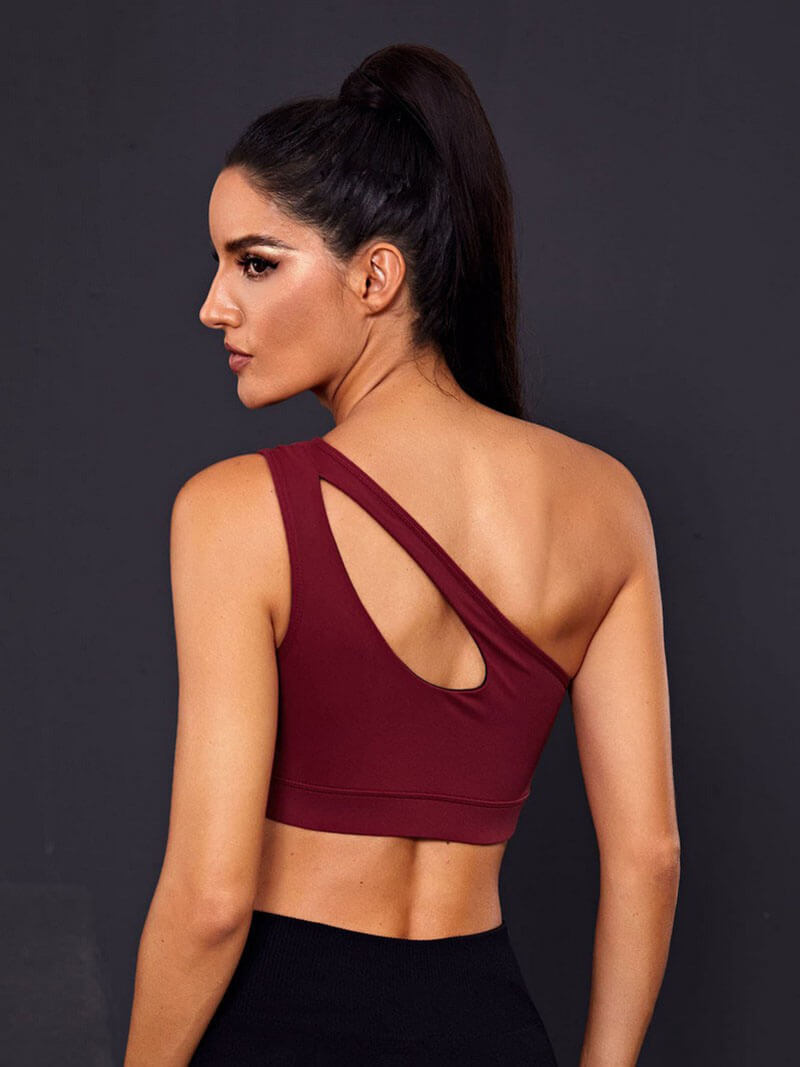 Back view of stylish women's one-shoulder maroon sports bra, perfect for fitness activities, made of breathable spandex and nylon.