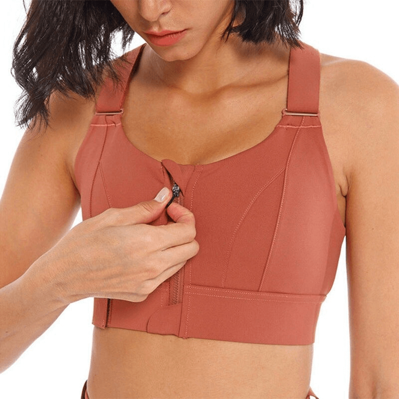 Woman adjusts Stylish Women's Shockproof Sports Bra with adjustable fastening, offering support and comfort for fitness activities.