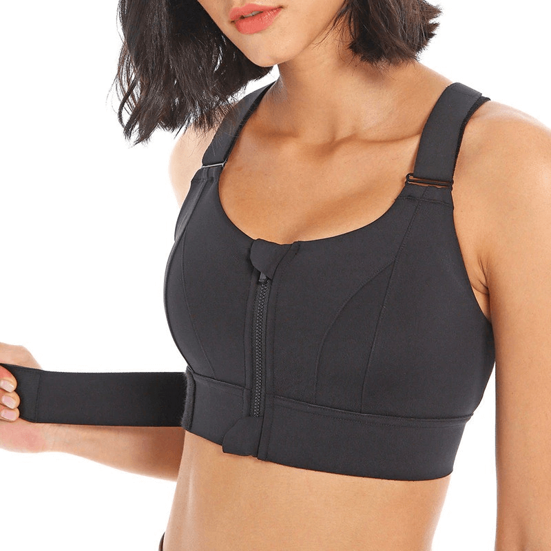Woman wearing a stylish black shockproof sports bra with adjustable fastening, perfect for fitness activities and support.