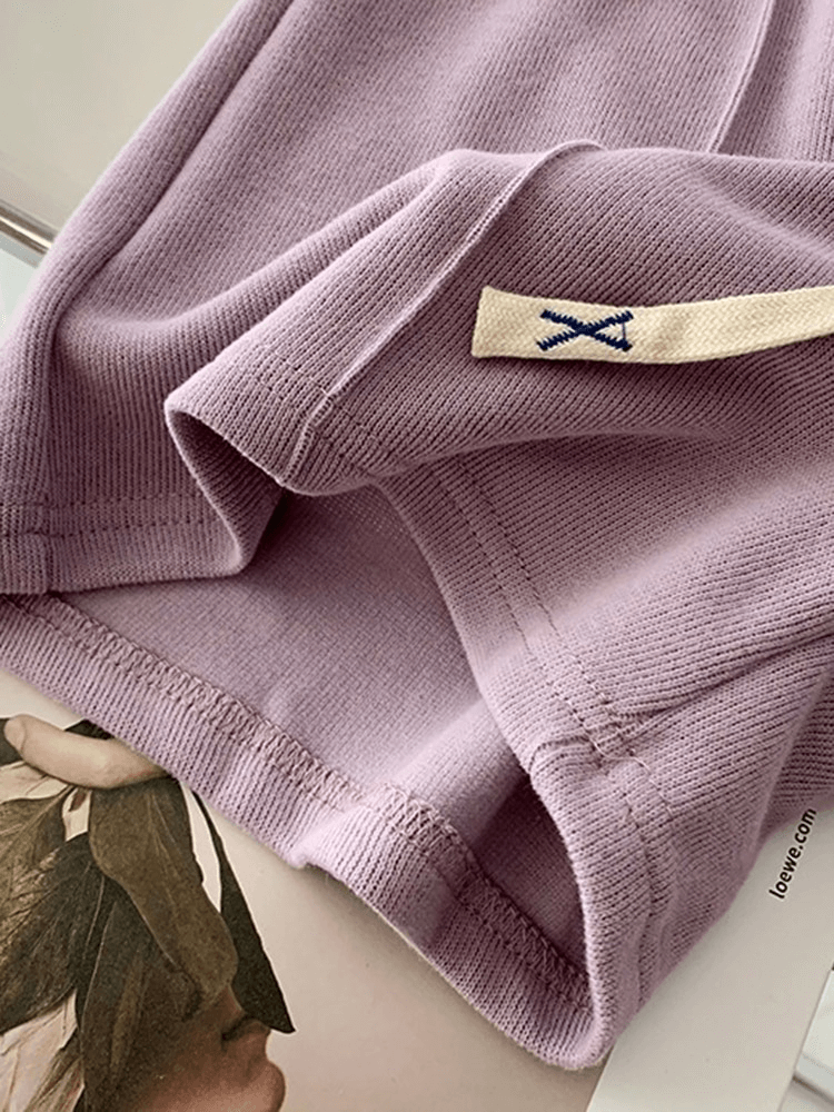 Close-up of light purple fabric showcasing texture and quality, ideal for women's clothing like stylish shorts with high waist.