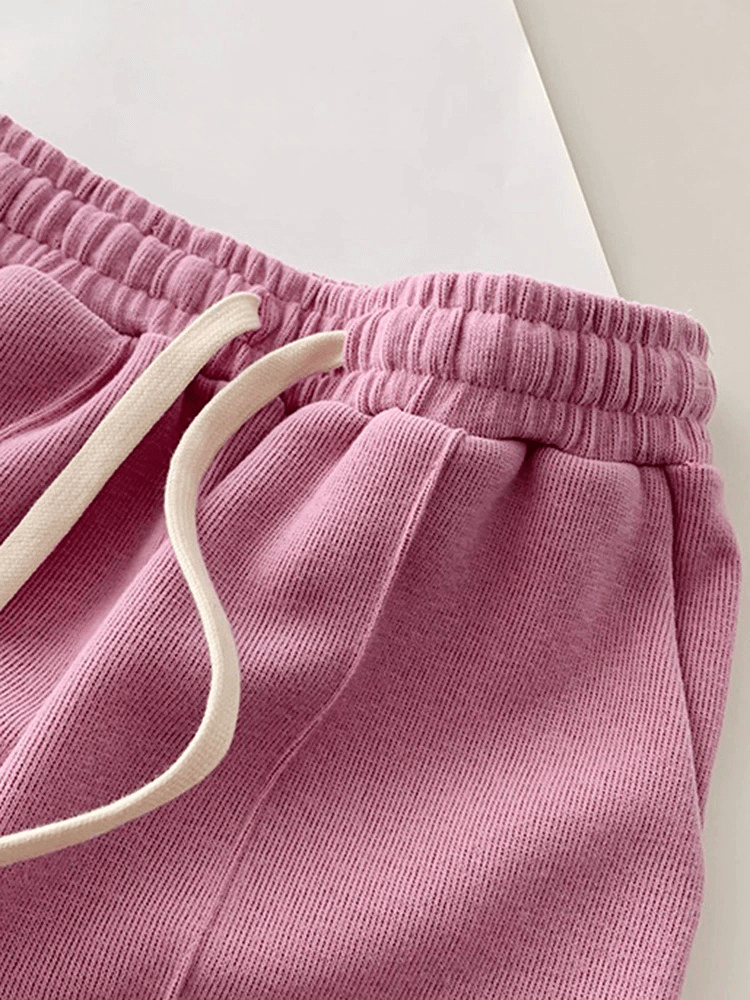 Pink high-waisted women's shorts with elastic drawstring waistband and side pockets made of premium cotton.