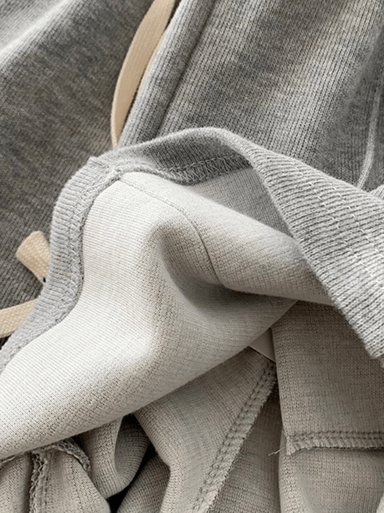 Close-up of premium cotton fabric in gray and beige, highlighting the textured quality and craftsmanship.