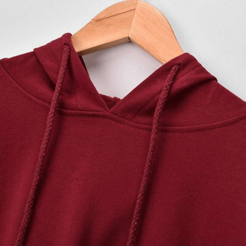 Close-up of a stylish women's maroon sports hoodie with drawstrings, showcasing its soft fabric and cozy design for workouts and casual wear.