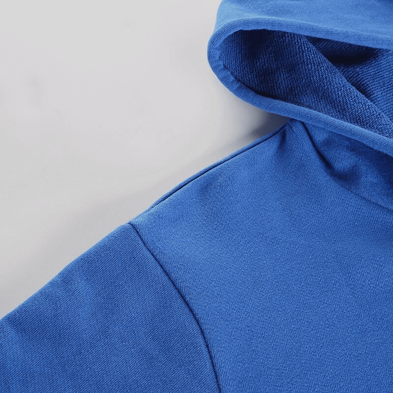 Close-up of blue stylish women's sports hoodie, focusing on the soft fabric and cropped cuffed design for yoga and workouts.