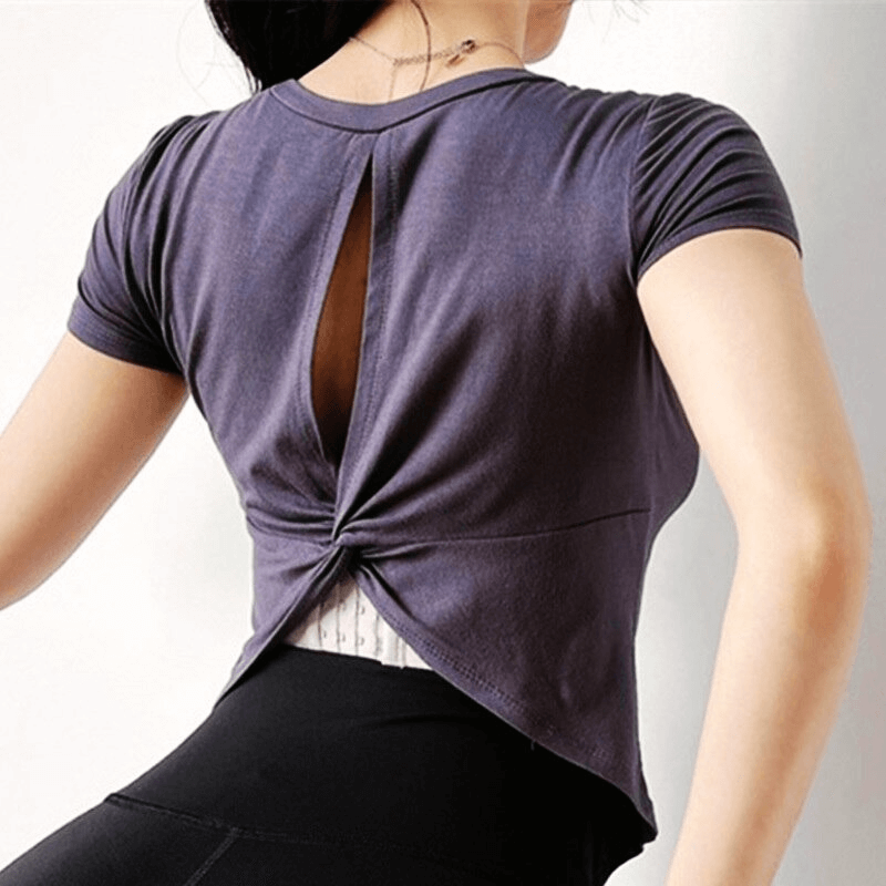 Cropped sports top with open back, short sleeves, and breathable fabric, perfect for yoga. Stylish women's top in nylon and spandex.