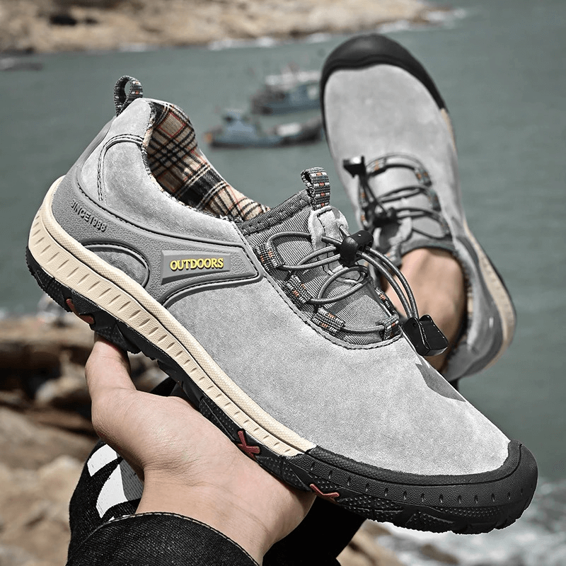 Gray suede leather non-slip hiking shoes with elastic band for men, showcased against a scenic outdoor backdrop. Model SF0719.