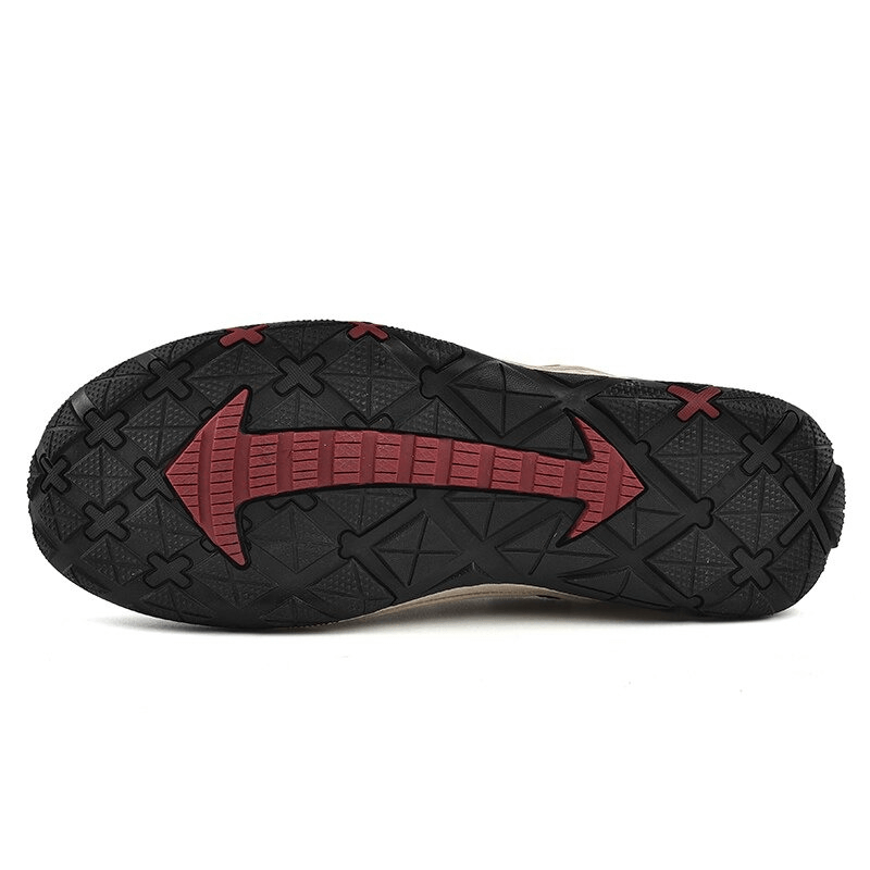 Close-up of the non-slip sole of men's suede leather hiking shoes, featuring red and black traction design for better grip on trails.