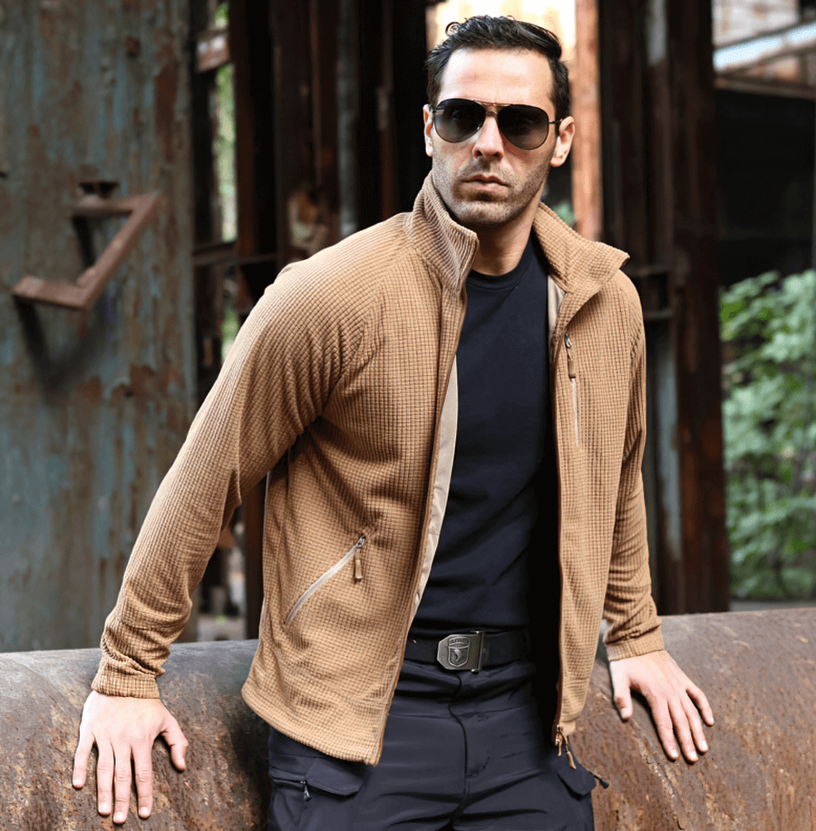Stylish man wearing Tactical Lightweight Fleece Jacket in Khaki, perfect for warmth and wind resistance. Ideal army clothing.