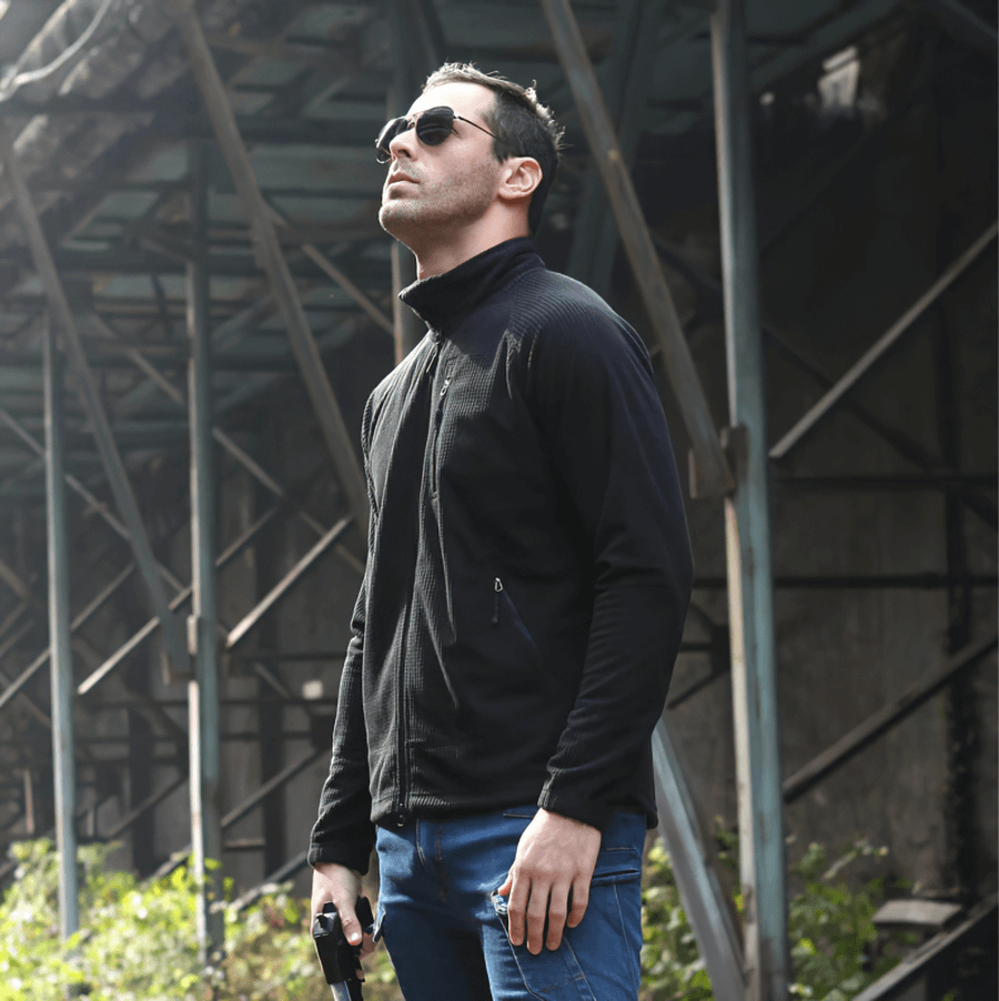 Man wearing Tactical Lightweight Fleece Jacket for Men, perfect as warm army clothing. Available in black, army green, khaki.