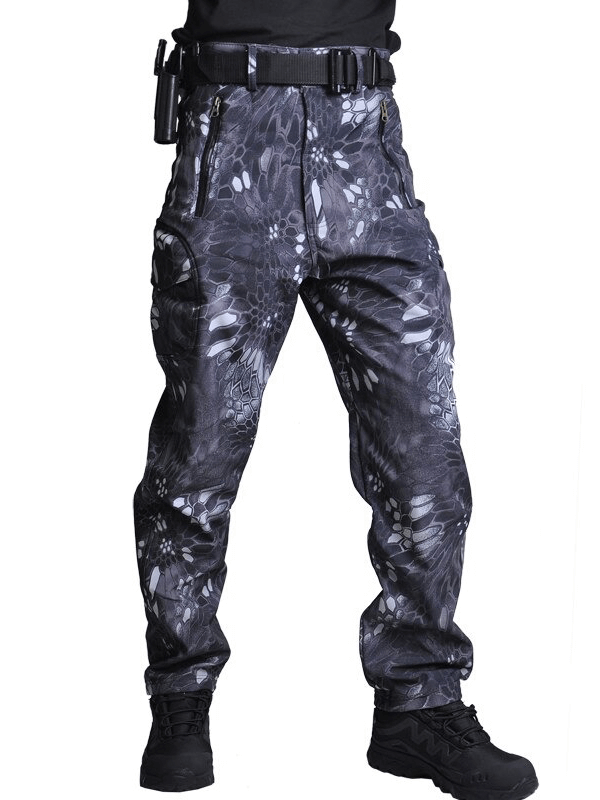 Men's tactical waterproof pants in camouflage pattern, showing rugged outdoor design and military style for hiking and camping.