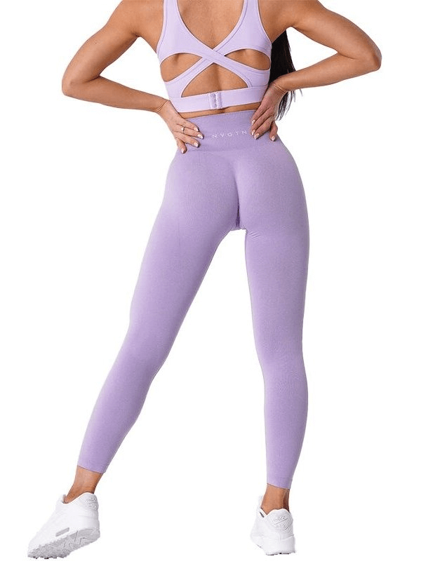 Back view of woman in purple tight elastic women's leggings designed for yoga, fitness, and running, ensuring comfort and movement flexibility.