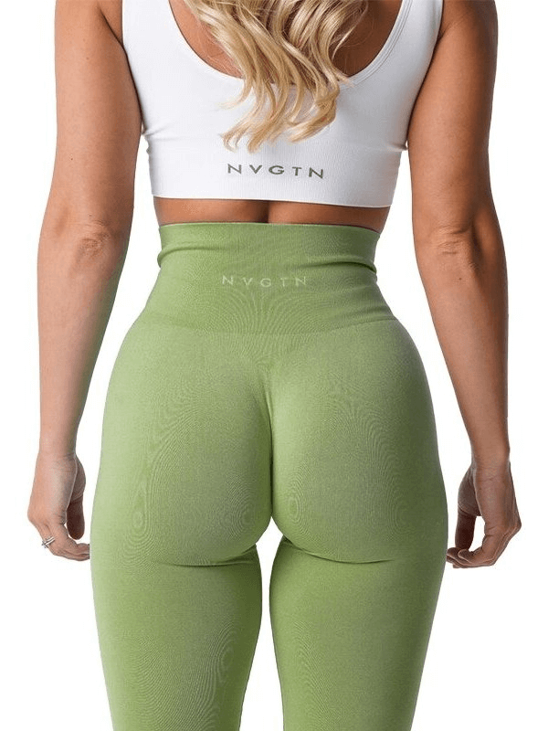 Back view of woman wearing green high-waisted sports leggings and white top, showcasing elastic fit for active workouts.