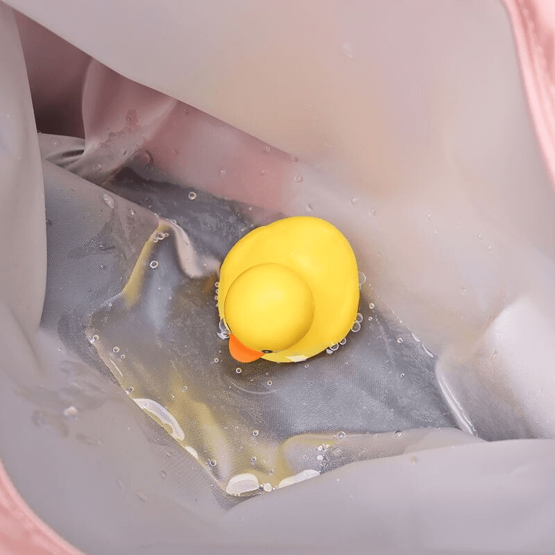 Yellow rubber duck sitting in a splashing puddle