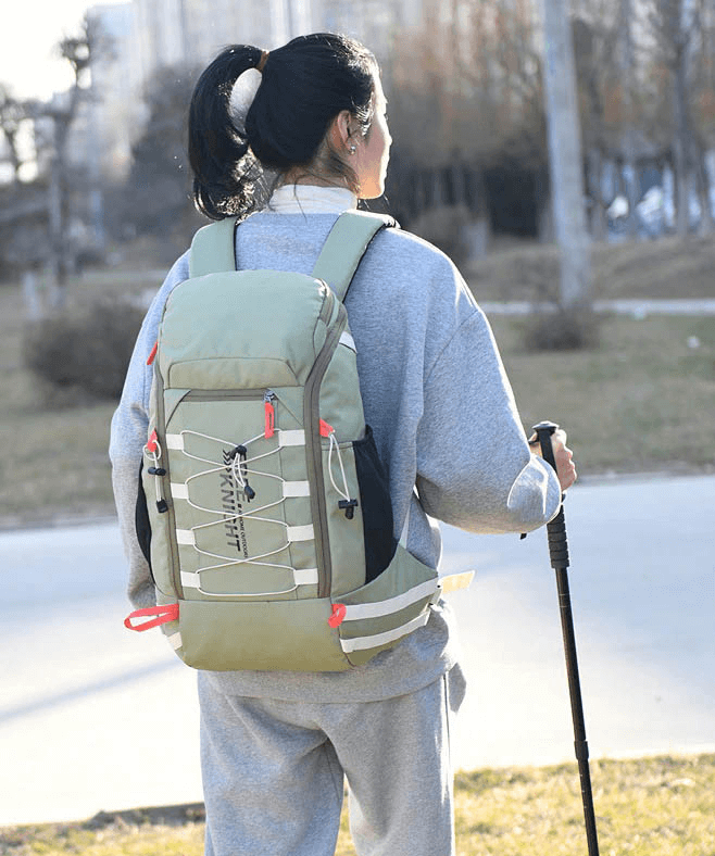 Traveler with 40L outdoor backpack featuring rain cover, soft handle, and ample storage, perfect for hiking adventures.