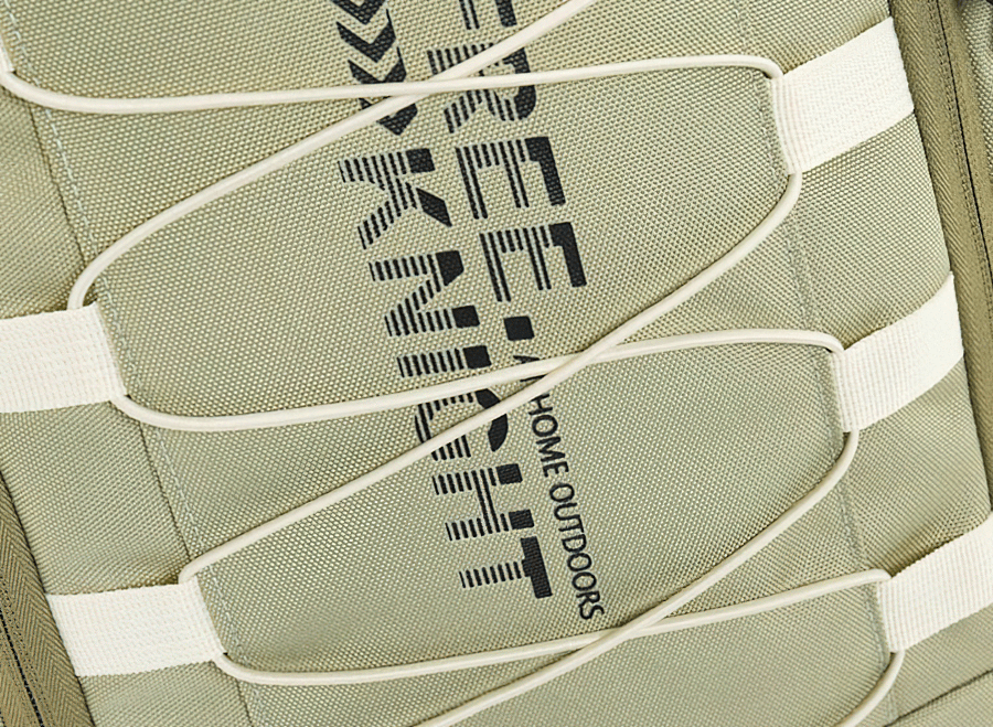 Close-up of green travel backpack with elastic cord detailing and 'Free Knight' branding